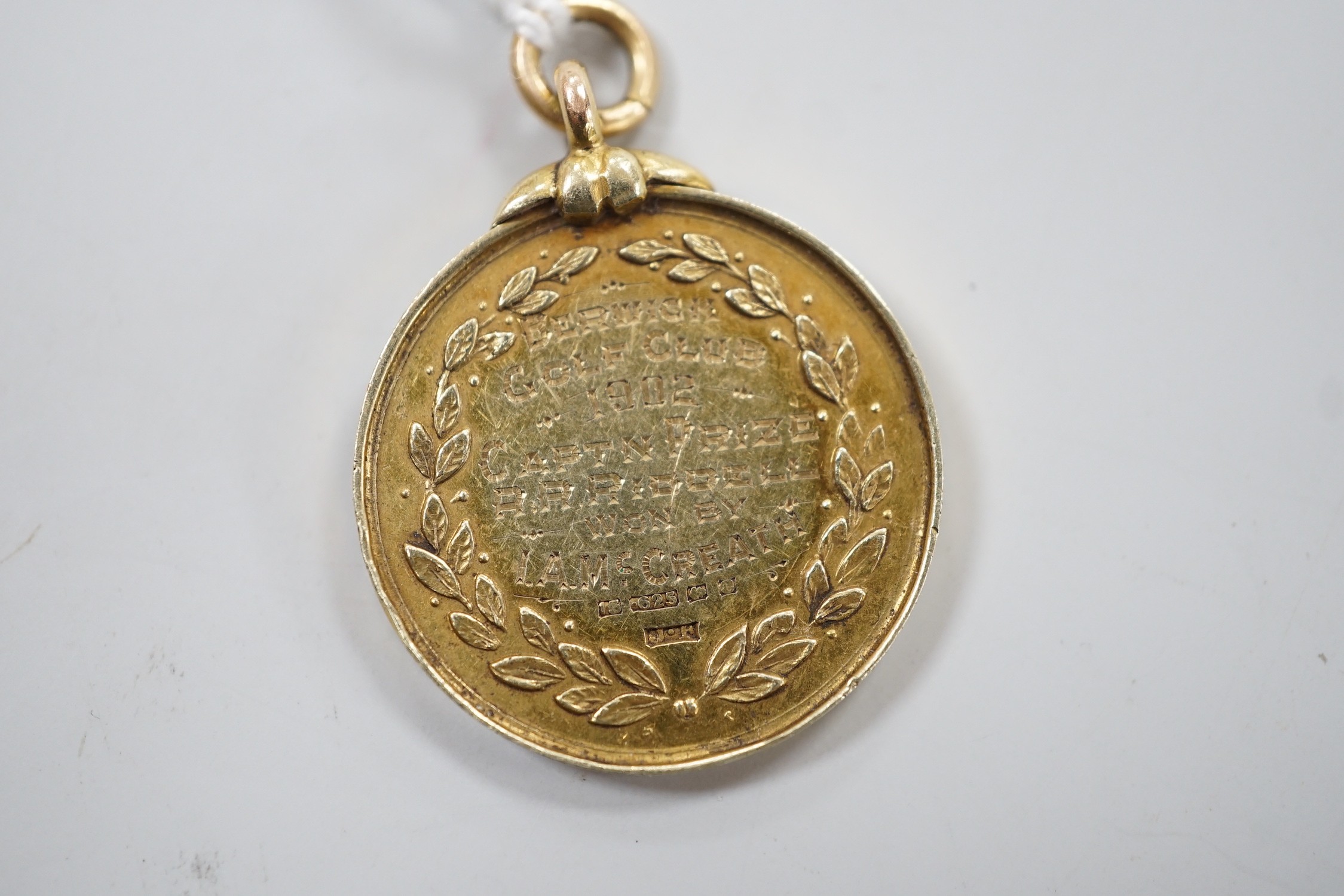 An Edwardian 15ct gold golfing medal, engraved 'Berwick Golf Club, 1902, Captn Prize R.R. Riddell won by I.A. McCreath', 26mm, 12 grams.